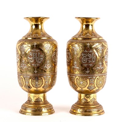 Lot 335 - A pair of Eastern brass baluster vases, inlaid...