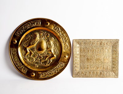 Lot 407 - A circular brass tray embossed a coat of arms,...