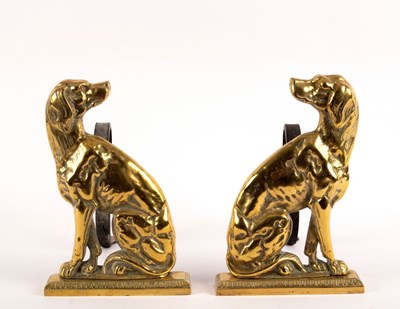 Lot 434 - A pair of brass fire dogs, each modelled as a...