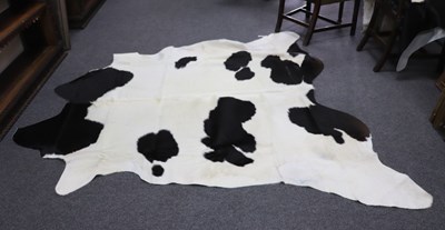 Lot 488 - Two black and white hide skin rugs, 216cm x...