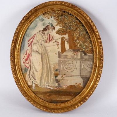 Lot 502 - A Georgian oval needlework sampler of a woman...