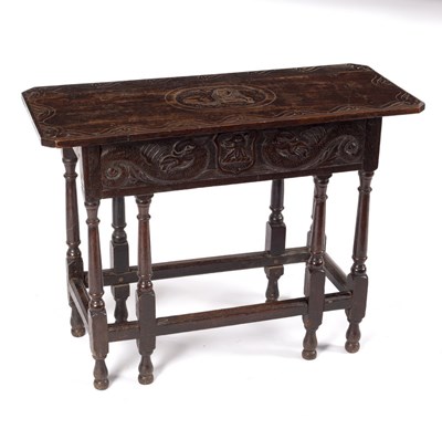 Lot 551 - A carved oak side table, 17th Century and...