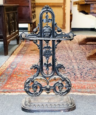 Lot 552 - A cast iron umbrella stand, with foliate and...