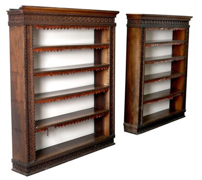 Lot 559 - A pair of Anglo-Indian teak open bookcases...