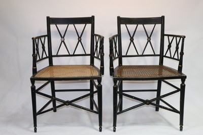 Lot 565 - A pair of Regency ebonised cane seat armchairs...