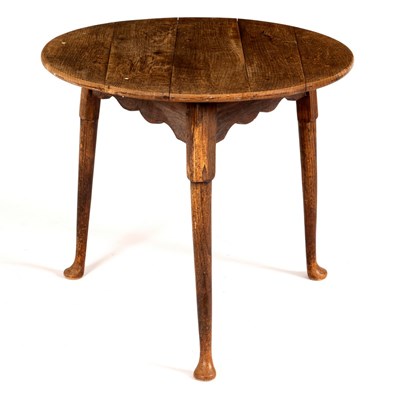 Lot 566 - An oak cricket table raised on plain round...