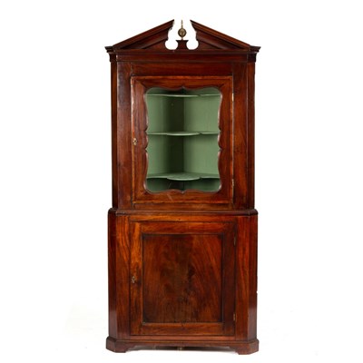 Lot 576 - An early 19th Century mahogany corner cupboard...