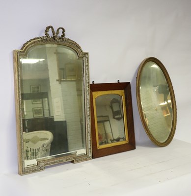 Lot 629 - A gilt framed wall mirror with ribbon cresting...