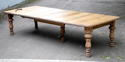 Lot 693 - A bleached oak extending dining table with...