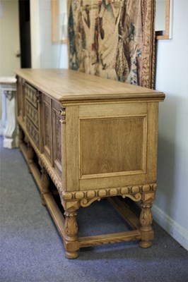 Lot 695 - A bleached oak sideboard, the three drawer...