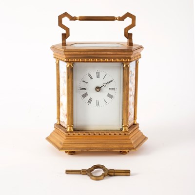 Lot 751 - A gilt brass mantle clock set with porcelain...