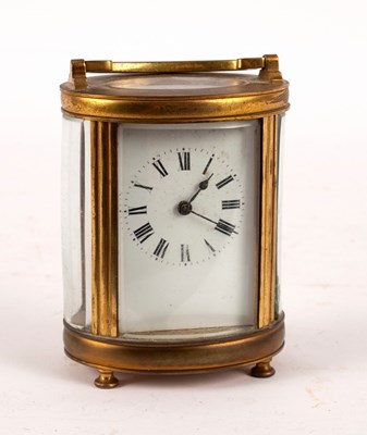 Lot 755 - A carriage clock in an oval gilt brass case,...