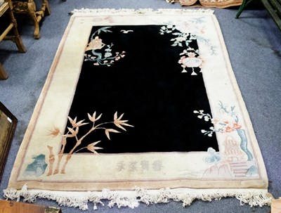 Lot 779 - A Chinese washed rug with black central ground...