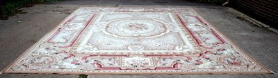 Lot 790 - A large Aubusson style carpet, the central...