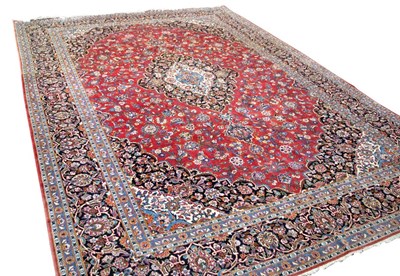 Lot 791 - A Kashan carpet, the red field with blue and...