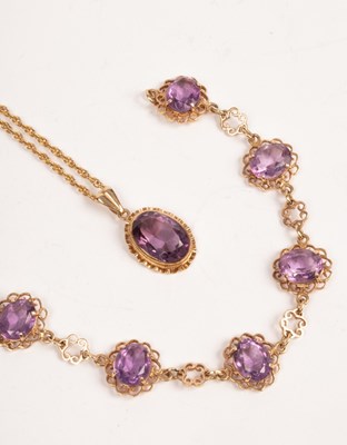 Lot 42 - An amethyst pendant on chain and an amethyst...