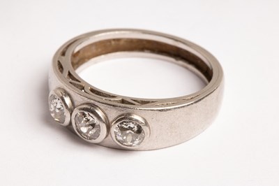Lot 55 - A platinum and diamond three-stone ring,...