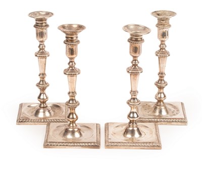 Lot 118 - A set of four George II silver candlesticks,...