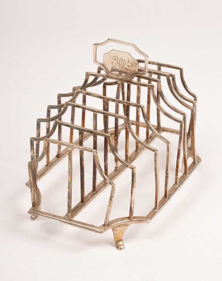 Lot 120 - A George III silver toast rack, makers mark HG,...