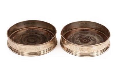 Lot 194 - A pair of George III silver wine coasters,...