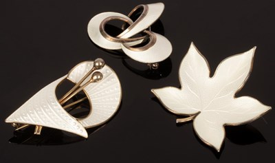 Lot 6 - Three white enamel brooches, one of stylised...