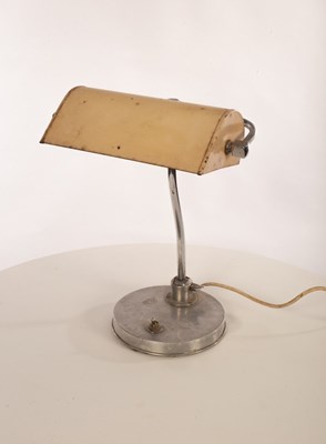 Lot 45 - A metal desk lamp, the adjustable shade on...