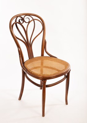 Lot 58 - A Thonet bentwood chair with stylised heat...