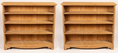 Lot 75 - A near pair of oak open bookcases, 125cm and...