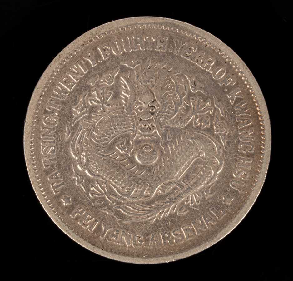 Lot 501 - A Chinese silver coin, one side with relief of...