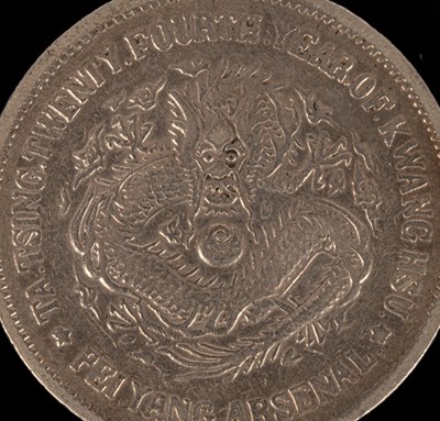 Lot 501 - A Chinese silver coin, one side with relief of...