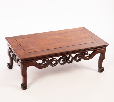 Lot 559 - A Chinese hardwood carved Kang table, 20th...