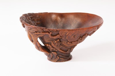 Lot 570 - A Chinese Rhinoceros horn carved libation cup,...