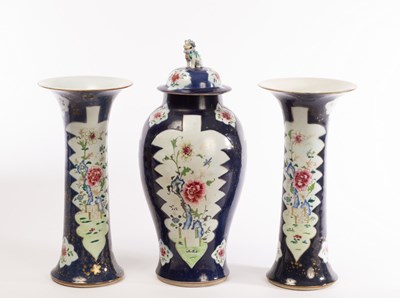 Lot 598 - A garniture of three famille rose vases,...