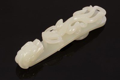 Lot 623 - A Chinese white jade carved belt hook, Qing,...