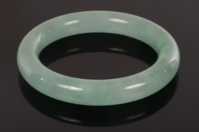 Lot 628 - A jadeite bangle, 20th Century, 8.1cm diameter