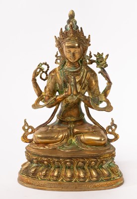 Lot 748 - A Chinese yellow bronze seated four-arm...