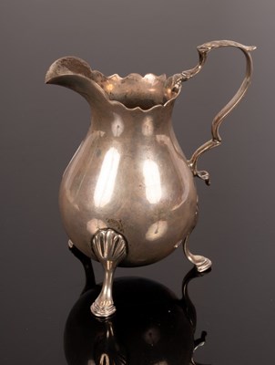 Lot 39 - A George III helmet-shaped silver cream jug,...