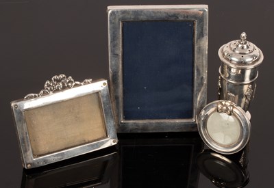 Lot 60 - Three easel back silver photograph frames, the...