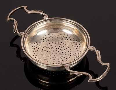Lot 75 - A two-handled silver tea strainer, Sheffield...
