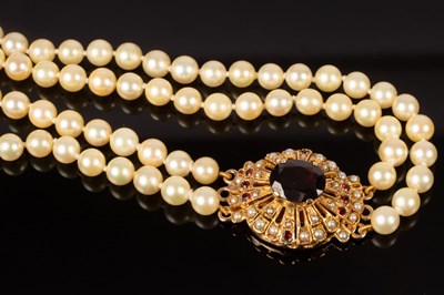 Lot 178 - A two-row cultured pearl necklace with garnet...