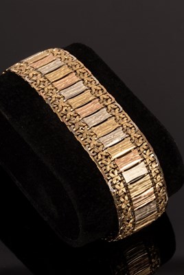 Lot 185 - A tri-colour textured 9ct gold bracelet, 20cm...