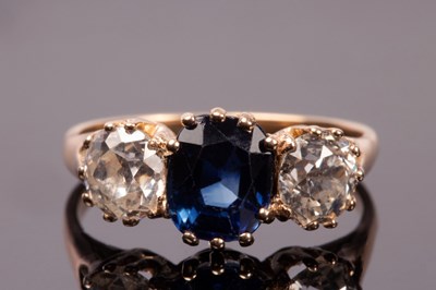 Lot 197 - A sapphire and diamond three-stone ring, the...