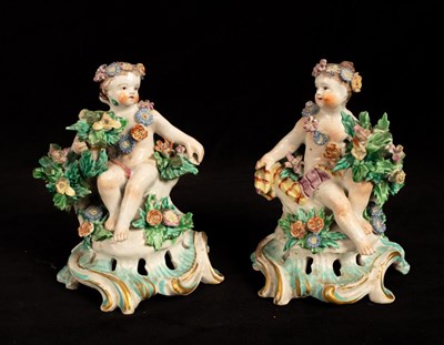 Lot 404 - A pair of Bow porcelain seated cherub...