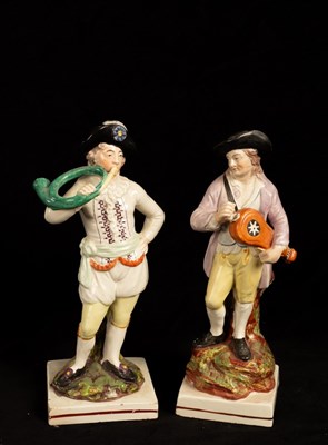 Lot 410 - Two pearlware figures of musicians, 23.5cm high