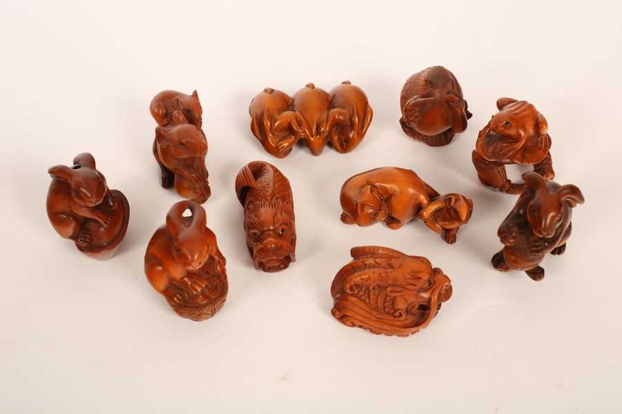 Lot 484 - Ten Japanese carved boxwood netsuke, 20th