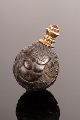 Lot 511 - A carved nut scent bottle of ovoid form...