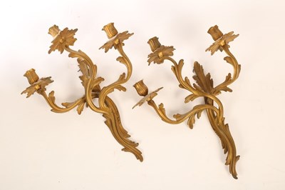 Lot 526 - A pair of gilt metal three-branch wall lights...