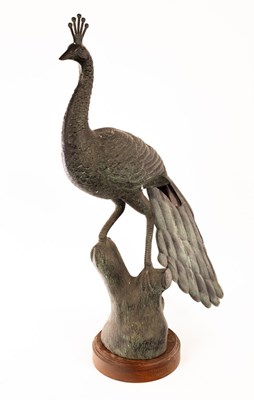 Lot 558 - A modern bronze finish figure of a peacock, on...