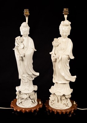 Lot 958 - A near pair of blanc de chine figural lamp...