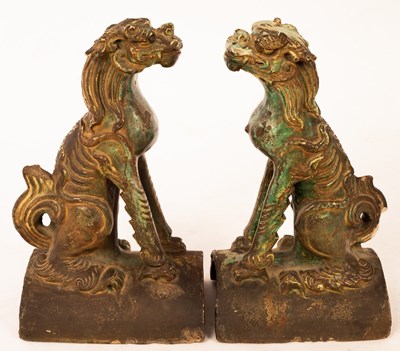 Lot 1025 - A pair of 17th Century green glazed ridge...